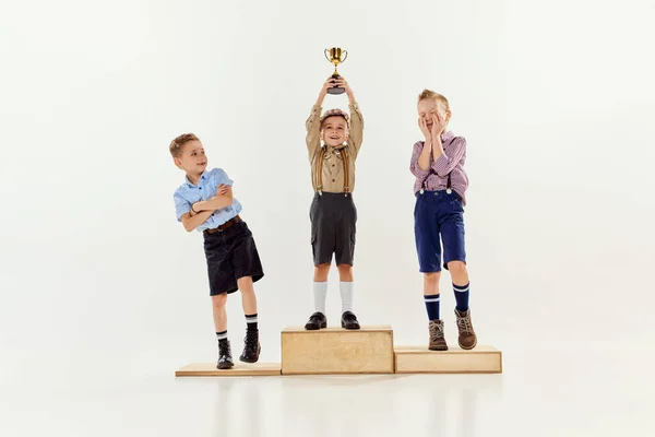 Three Boys Children Standing Rewarding Stairs Holding Prize Grey Studio — Stock Photo, Image