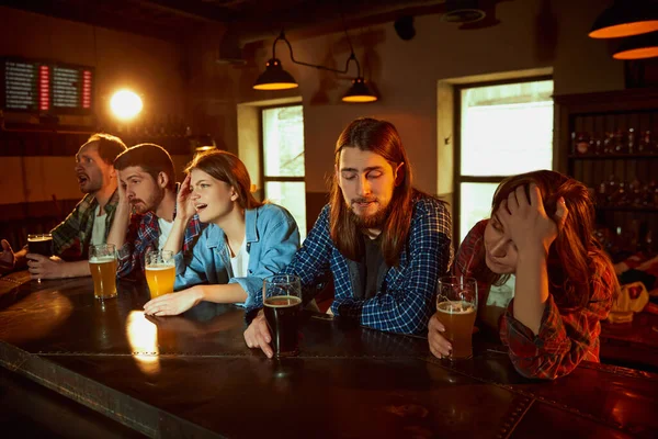 一群年轻人 男男女女在酒吧观看比赛 紧张的游戏时刻 输的游戏 压抑的情绪 锦标赛 比赛翻译 粉丝的情绪 — 图库照片