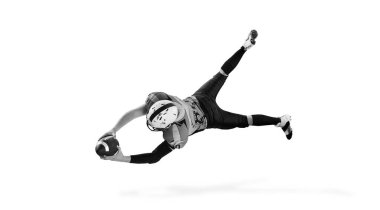 Black and white photography. Man, american football player in motion, training over white studio background. Concept of sport, movement, achievements, competition, hobby. Copy space for ad