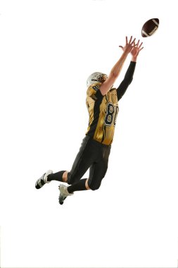 Catching ball in a jump. Man, american football player in motion, training over white studio background. Active game. Concept of sport, movement, achievements, competition, hobby