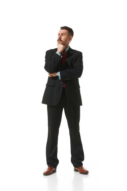 Businessman in a suit standing with thoughtful serious face over white studio background. Working day. Concept of business, career development, ambitions, innovative strategy. Copy space for ad
