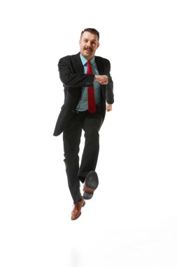 Front view. Businessman in a suit with positive mood walking to work over white studio background. On way to goal. Concept of business, career development, ambitions, strategy. Copy space for ad