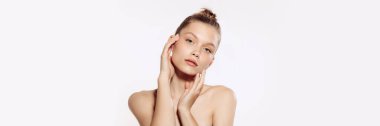 Tender, young, beautiful girl with perfect well-kept skin over white background. Taking care after skin with natural cosmetics. Concept of cosmetology, plastic surgery, natural beauty. Banner, flyer.