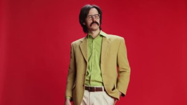 Serious man, businessman in vintage suit and glasses shouting in megaphone over red background. Journalism, occupation. Concept of emotions, business, occupation, facial expression, fashion