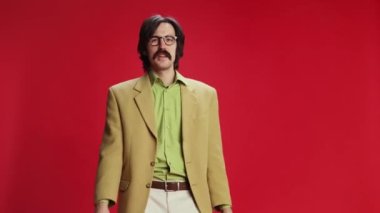 Emotional man, businessman in vintage suit and glasses shouting in megaphone with happy expression over red background. Success. Concept of emotions, business, occupation, facial expression, fashion