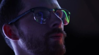 Stable financial growth of company. Close up view of mans eyes in glasses looking at pc screen with computer reflection at eyewear. Analytics. Modern technologies, IT, trading, business, finances.