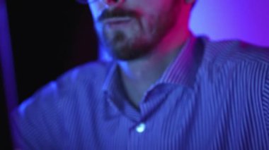 Focused businessman in eyeglass working, looking on laptop screen reflecting analytics, graphs, financial charts. Professional occupation. Modern technologies, IT, trading, business, finances.