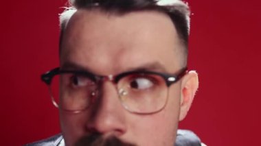 Control over employees. Businessman, team manager closely looking, checking workers over red background. Management. Concept of emotions, business, occupation, facial expression, fashion