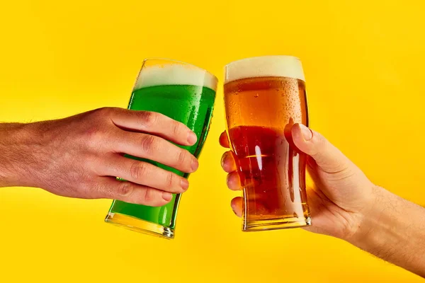 Cheers Hands Clinking Green Lager Foamy Beer Glasses Yellow Background — Stockfoto