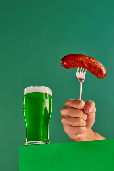 Glass Foam Green Beer Make Hand Sausage Fork Green Background — Stok fotoğraf