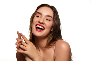 Perfect smile. One beautiful brunette girl with well-kept healthy skin posing against white studio background. Dental care. Concept of natural beauty, youth, health, wellness, femininity, make-up