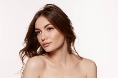 Well-kept skin. Portrait of young beautiful woman with perfect smooth skin isolated over white background. Concept of natural beauty, plastic surgery, cosmetology, cosmetics, skin care.