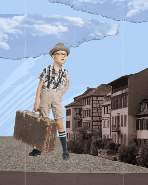 Contemporary art collage. Creative abstract design. Little boy, child with vintage suitcase standing near building. Traveller. Concept of childhood, dreams, surrealism, travelling. Retro style