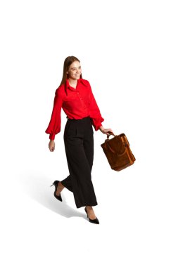 Happiness. Young employee, woman in official clothes walking, posing over white studio background. Isometric view. Concept of career development, employment, business, job. Ad