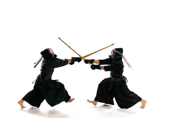 最上階だ 白スタジオを背景にした新内剣でプロの剣道選手2人のダイナミックなイメージ スポーツ 日本文化 運動の概念 — ストック写真