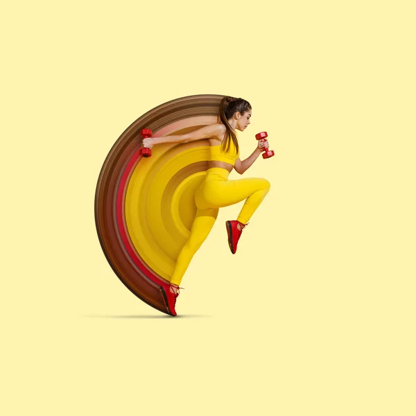 Modern creative design with abstract elements. Sportive slim girl training with sports equipment on bright yellow studio background. Female sport, motion, beauty concept. Fitness, healthy lifestyle