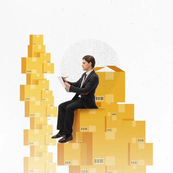 Conceptual modern art, design. Man sitting on boxes and writing in tablet. Inventory management and control. Concept of logistics, business, planning, management, analytics, delivery and distribution