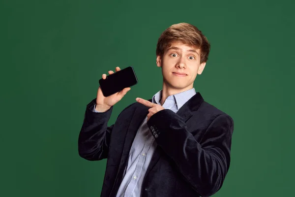 Portrait Young Man Stylish Jacket Pointing Mobile Phone Screen Green — Stock Photo, Image