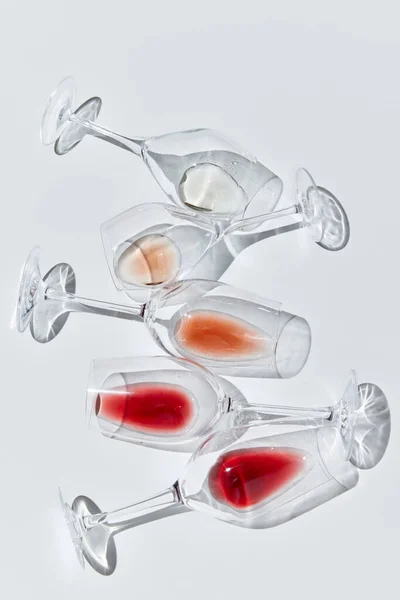 Art of traditional wine taste. Drops. Glasses filled with different red, white and rose wine against white background. Concept of taste, alcohol, wine degustation, variety, winemaking. Flat lay