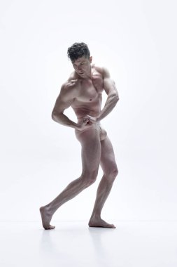 Showing strength. Full-length portrait of mature, handsome man with relief, muscular body posing shirtless against white studio background. Concept of male body aesthetics, mens beauty, inspiration clipart