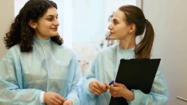 Kadın cerrah, veteriner ve asistan başarılı bir ameliyattan sonra neşeli bir şekilde konuşuyorlar. Hayvanlara bakmak sağlık, tıbbi bakım. Veteriner kliniği kavramı, hayvan, sağlık, bakım, tedavi