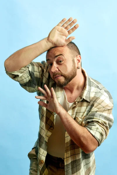 Portrait Bearded Man Checkered Shirt Leaning Transparent Glass Blue Studio — Stock Photo, Image