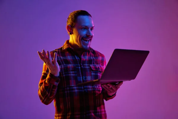 Mutlu Gülümseyen Adamın Portresi Için Dizüstü Bilgisayar Kullanıyor Neon Işıktaki — Stok fotoğraf