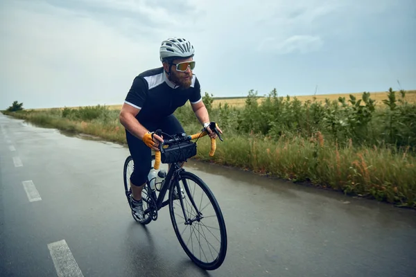 Bearded Young Man Cyclist Helmet Glasses Uniform Riding Bike Wet — Stock Photo, Image
