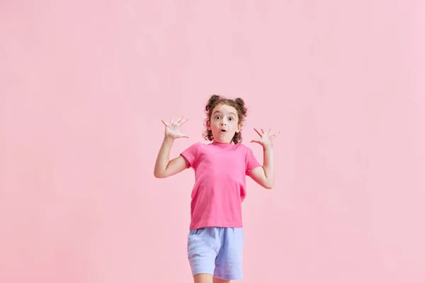 一个情绪激动的小女孩的画像 孩子在粉红的工作室背景下表现出兴奋和惊奇 情感概念 生活方式 — 图库照片