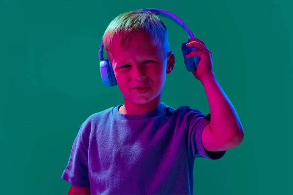 Child Little Boy Listening Music Headphones Cyan Studio Background Neon — Stock Photo, Image