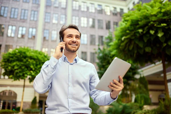Partnership Young Businessman Standing Office Outdoors Looking Tablet Talking Mobile — Stock Photo, Image