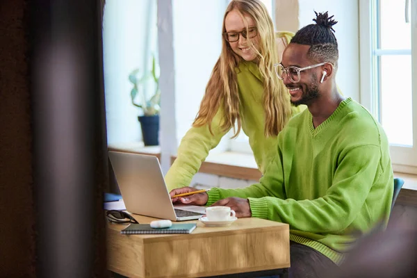 stock image Smiling young man and woman looking on laptop, working together on project online, remotely. Cooperation. Concept of business and education, freelance job, modern lifestyle