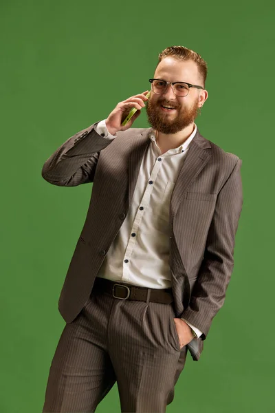 Portrait Bearded Man Glasses Suit Cheerfully Talking Mobile Phone Green — Stock Photo, Image