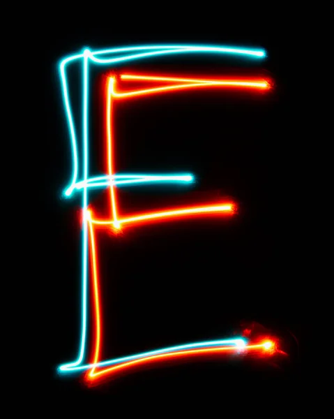 ネオンサインから作られたアルファベットのEの文字 青い赤い光のイメージ 黒い背景に対して着色された妖精のライトが付いている長い露出 デザインコンセプト — ストック写真
