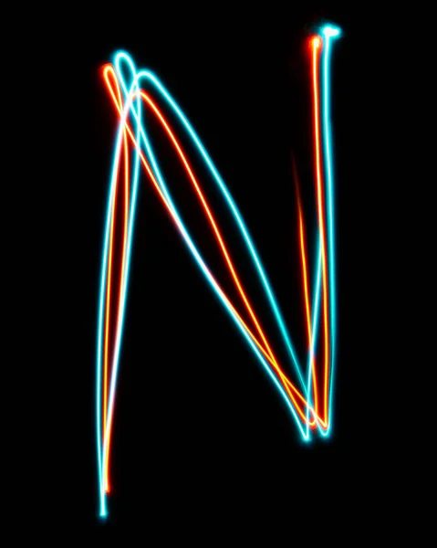 Letter N of the alphabet made from neon sign. The blue red light image, long exposure with colored fairy lights, against a black background. Concept of design
