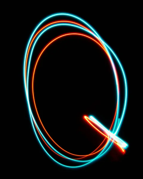 Letter Q of the alphabet made from neon sign. The blue red light image, long exposure with colored fairy lights, against a black background. Concept of design