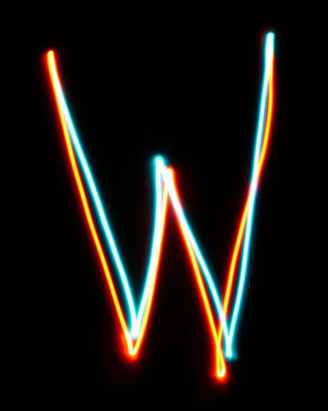 Letter W of the alphabet made from neon sign. The blue red light image, long exposure with colored fairy lights, against a black background. Concept of design
