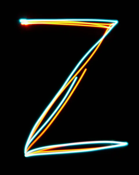 Letter Z of the alphabet made from neon sign. The blue red light image, long exposure with colored fairy lights, against a black background. Concept of design