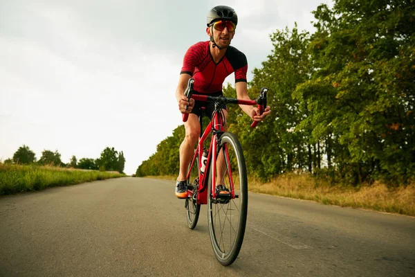 Dynamic Image Motivated Sportsman Athlete Riding Bicycle Road Training Outdoors Royalty Free Stock Images