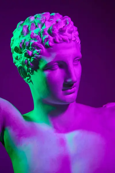 人間の石膏像 ネオンライトの紫色のスタジオ背景に対するアンティーク彫像バスト アンティークスタイル クラシックアート 博物館 神話の概念 ポスター — ストック写真