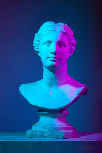 Venus statue. Antique statue bust, Greek sculpture against gradient studio background in neon lights. Concept of antique style, classic art, museum, history and mythology. Poster, ad