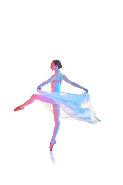 Young artistic woman, ballerina in bodysuit spinning on pointe, dancing with transparent fabric isolated on white background in neon. Concept of beauty, classical dance, art, elegance, choreography