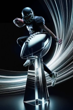 Professional American football player in motion with ball over dark background. Champion. Success. Winning trophy. Concept of sport event, championship, betting, game. Poster for ad clipart