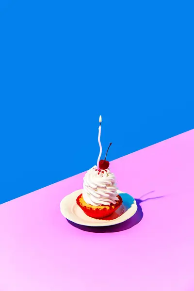 Delicious sweet cake on plate with cream and birthday candle against blue pink background. Taste of cherry.. Concept of food, desserts, birthday celebration, party. Pop art. Copy space for ad. Poster