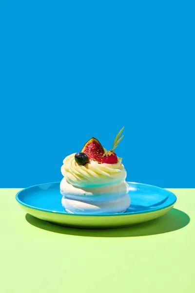 Plate with delicious meringue desserts with fresh berries against blue green background. Popular dessert . Concept of food, desserts, birthday celebration. Pop art style. Copy space for ad. Poster