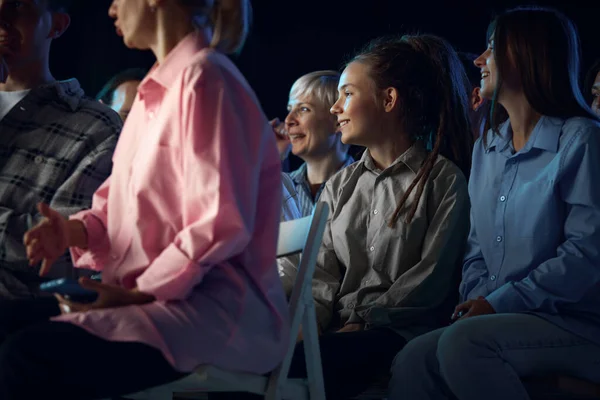 Group of people attending stand up show, concert. Actor, comedian cooperating with audience, asking questions. Concept of entertainment, fun and joy, concert, performance