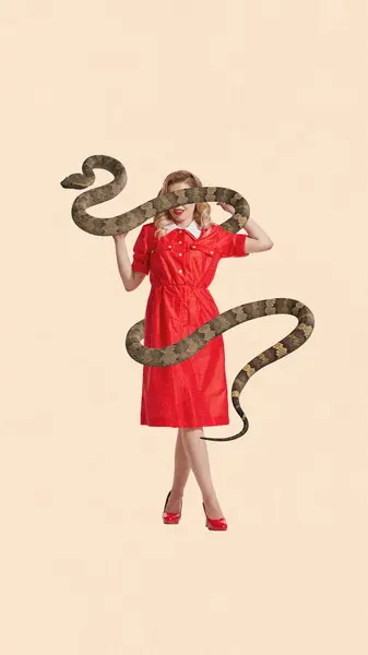 Contemporary art collage. Full length portrait of young woman wearing long red dress and snake wrapped her body and covered eyes against peach background. Concept of feminine strength, wisdom.