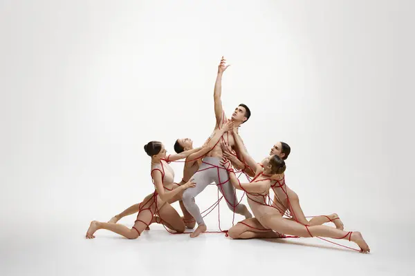 Ballet Dancers Connected Red Ribbons Forming Pyramid White Studio Background — Stock Photo, Image
