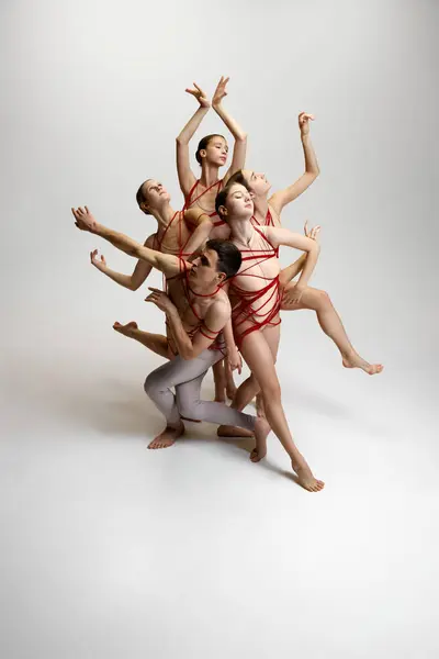 Group Ballet Dancers Tied Together Red Strings Creating Intricate Pose — Stock Photo, Image