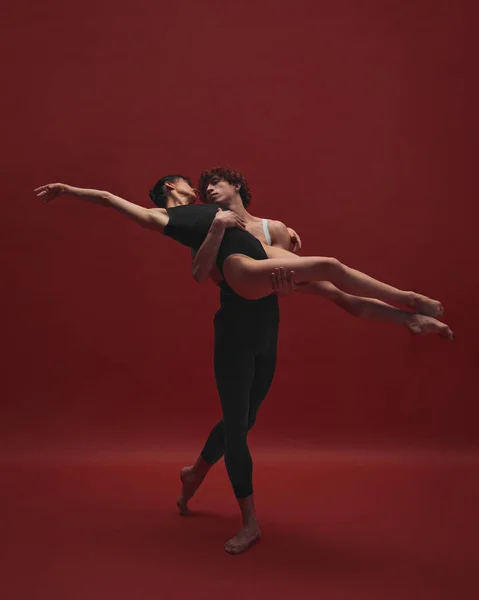 优雅的年轻女子和英俊的男子 芭蕾舞演员在红色背景下跳舞 黑色和红色 古典艺术 芭蕾舞 天才的概念 — 图库照片